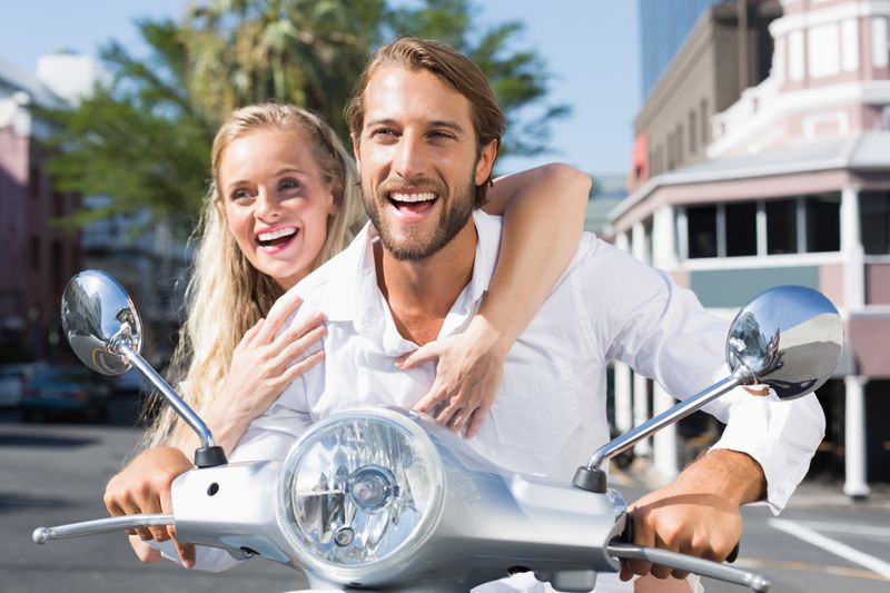 Couple riding a scooter
